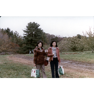 People carrying apples during a Chinese Progressive Association trip