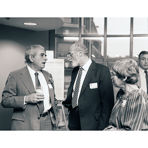 George Kariotis talking to a man and woman at the Kariotis Hall dedication