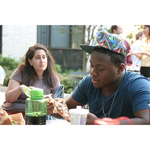 Ulysses Ifill eats pizza at the Torch Scholars Question and Answer Pizza Party