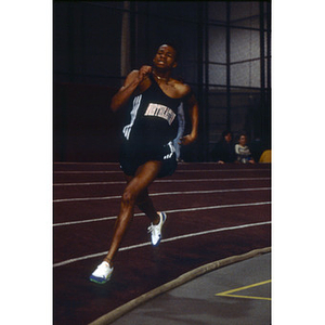 A Northeastern student from the men's indoor track and field team competing in the Greater Boston Championships at Harvard