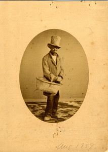 Studio portrait of a man in a stove pipe hat and with a basket, Aug. 1859
