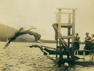 Women campers diving at the lake