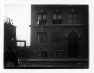 View of the corner of a building, probably on Dorchester Ave., with a horse on the left side