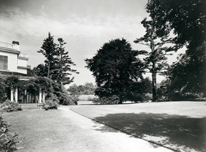 Landscape view of Lyman Estate porch, lawn, and greenhouses