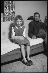 Peggy, daughter of Mildred and Richard Loving, seated on a couch with Richard's father