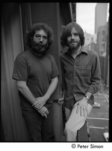 Jerry Garcia (left) and Bob Weir of the Grateful Dead standing on a balcony