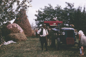 Men and women work around tractor