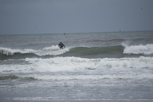 Surfer approaching a wave