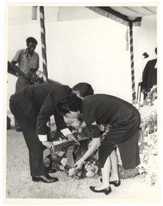 Unidentified man and woman lay a wreath at the graveside of W. E. B. Du Bois