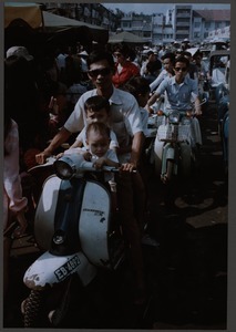 Father and sons on a scooter