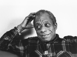 James Baldwin sitting indoors