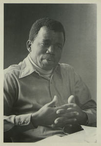 Chinua Achebe gestures while speaking
