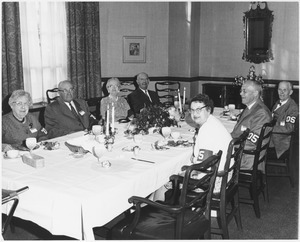 Members of the class of 1905 sitting at a banquet table at a reunion