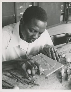 A man works on the 1951 president's trophy