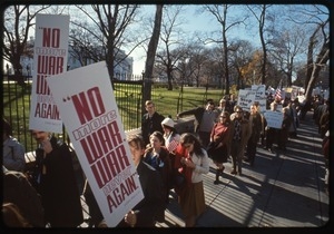 Antiwar protesters march past the white house with signs reading 'No more war, war never again': Washington Vietnam March for Peace