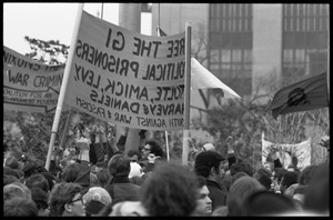 Crowd of marchers in the streets at the Counter-inaugural demonstrations, 1969, with banners 'Free the GI political prisoners'