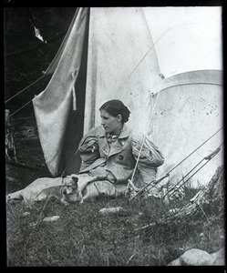 Elinor Frost and dog, seated in from of a tent