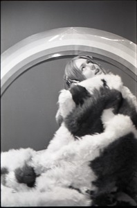 Lynn Smith wrapped in faux fur blanket, modeling Koss headphones