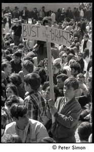 Resistance on the Boston Common: boy in the crowd holding a sign reading 'Bust the draft'