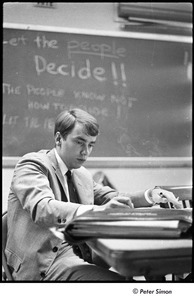 National Student Association Congress: unidentified man writing at a desk
