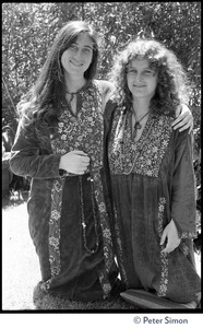 Dolma (left) and Usha (Cathy Brown): kneeling on the ground, Dolma's arm around Usha's shoulders