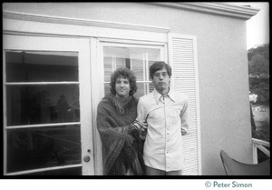 Jake Brackman (right) standing on a balcony with Peter Simon