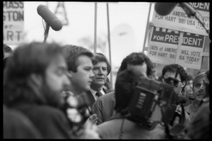 Gary Hart surrounded by press after renewing his bid for the Democratic nomination for the presidency