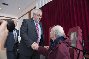 Congressman Barney Frank shaking hands with audience member as he leaves the Student Union Ballroom stage, UMass Amherst, during his book event