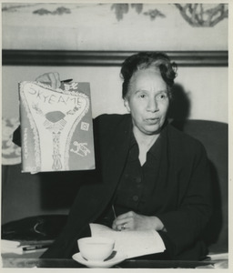 Shirley Graham Du Bois holding a copy of Okyeame magazine