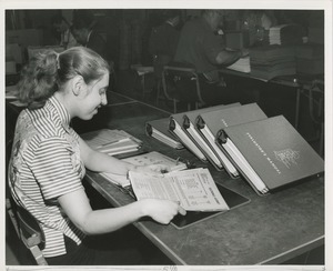 Woman assembling manuals