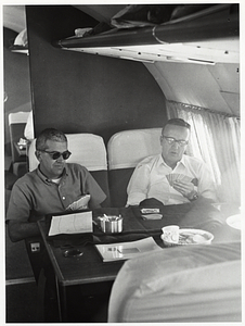 Two unidentified men playing cards on airplane