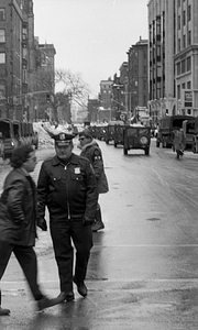 Unidentified officer, Military Police officer, and military vehicles