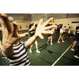 Group of women reaching their arms up