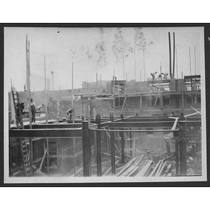 Builders working on frames at a construction site