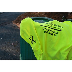 Florescent yellow lawn care sweatshirt sporting the Boston Strong logo
