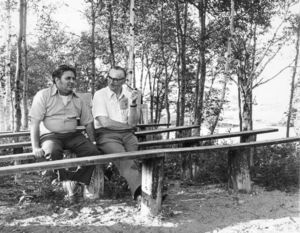 Professor Arthur J. West (left) and President Thomas A. Fulham (1970-1980) seated on bench at Suffolk University's R.S. Friedman Field Station in Cobscook Bay, ME