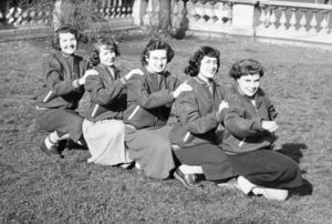 Suffolk University cheerleaders line up on the lawn near the State House steps, circa 1957