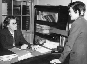 Suffolk University Professor Edith M. Marken (CAS), Department Chair Journalism, seated behind desk, 1940s