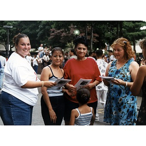 Yolanda Tubens handing out booklets to a group of women at Festival Betances 1999.