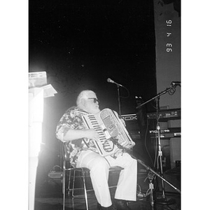 Man on stage at the Jorge Hernandez Cultural Center playing the accordion.
