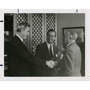 Paul G. O'Friel, on the left, shaking hands with Frederic C. Church