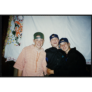 Three boys wearing their hats backwards pose for the camera at the Charlestown Best Year In School Program Awards Night