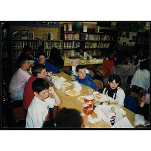 Several boys and girls eating at a table at the "Service Project Awards Luncheon at Edwards School"