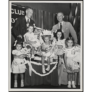 Five winners of the Boys' Club Little Sister Contest pose with two judges