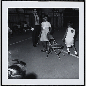 Two girls playing musical chairs during a Boy's Club's Little Sister Contest