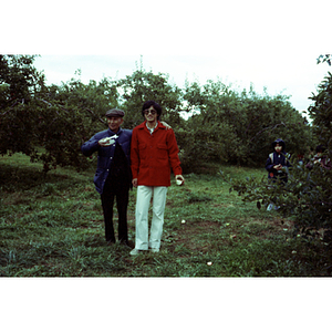 People in an orchard on a Chinese Progressive Association trip