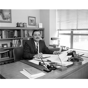 Rudolph Morris sits at his desk