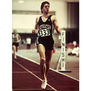 Male track athlete crossing the finish line