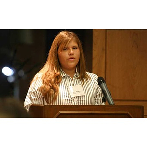 Nadia Alvarez speaks at the podium at the Torch Scholars dinner