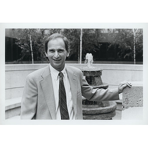 Daniel Givelber, Dean of the School of Law, posing by the fountain near the Thomas E. Cargill Hall